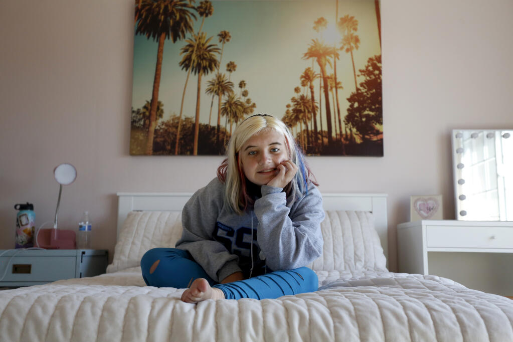 Designer Tama Bell remade Brinkley Woodward’s bedroom with a Hollywood theme of pale pink and palm trees. (Beth Schlanker/The Press Democrat)