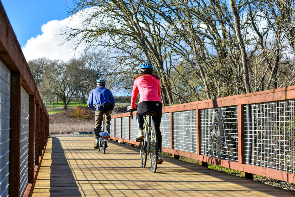 A couple bikes across the newly constructed bridge in Forestville. Courtesy of Sonoma County Parks.