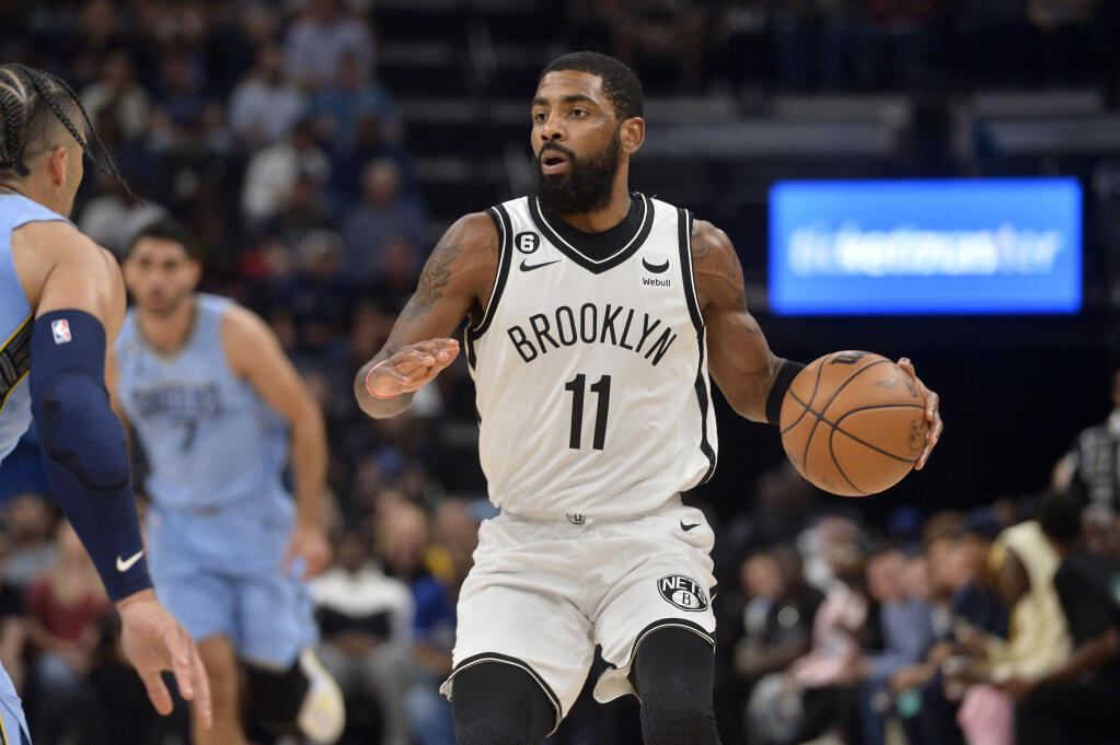Brooklyn Nets guard Kyrie Irving (11) handles the ball in the first half of an NBA basketball game against the Memphis Grizzlies Monday, Oct. 24, 2022, in Memphis, Tenn. (AP Photo/Brandon Dill)
