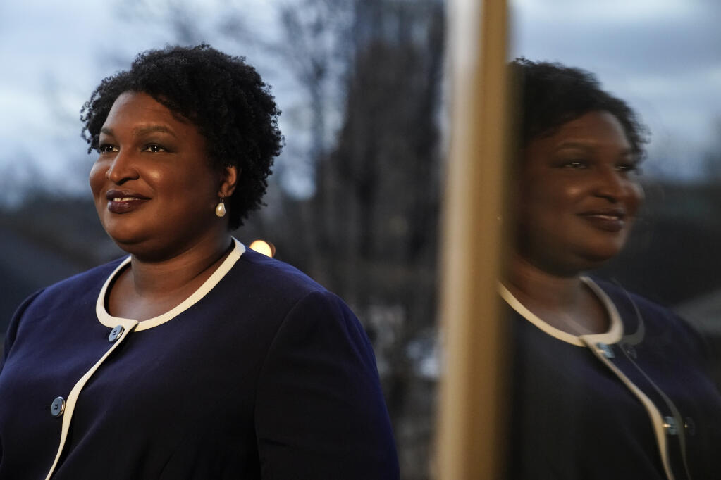 Georgia gubernatorial Democratic candidate Stacey Abrams poses for a photo during an interview with The Associated Press on Thursday, Dec. 16, 2021, in Decatur, Ga.   (AP Photo/Brynn Anderson)