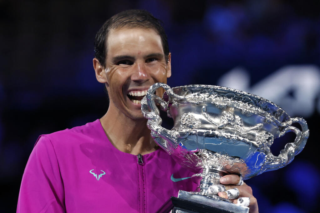 Rafael Nadal of Spain holds the Norman Brookes Challenge Cup after defeating Daniil Medvedev of Russia in the men's singles final at the Australian Open tennis championships in Melbourne, Australia, early Monday, Jan. 31, 2022. (AP Photo/Hamish Blair)