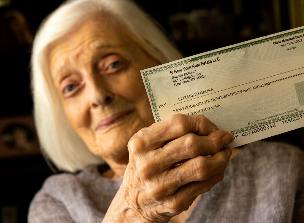 Elizabeth Gaona, 94, holds a realistic-looking fake check issued by the “Swiss Lotto” she received in the mail at her home in Windsor. Gaona is keen to expose scams like these targeting seniors, Monday, July 24, 2023.  (John Burgess / The Press Democrat)