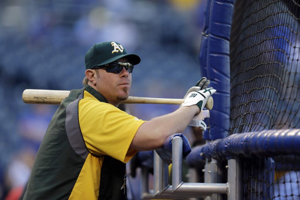 Oakland Athletics' Adam Dunn leans against the batting cage before the start of the AL wild-card playoff baseball game against the Kansas City Royals Tuesday, Sept. 30, 2014, in Kansas City, Mo. (AP Photo/Jeff Roberson)