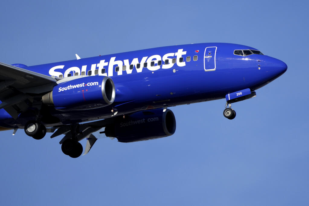 A Southwest Airlines aircraft lands at St. Louis Lambert International Airport Wednesday, Dec. 28, 2022, in St. Louis. (AP Photo/Jeff Roberson)