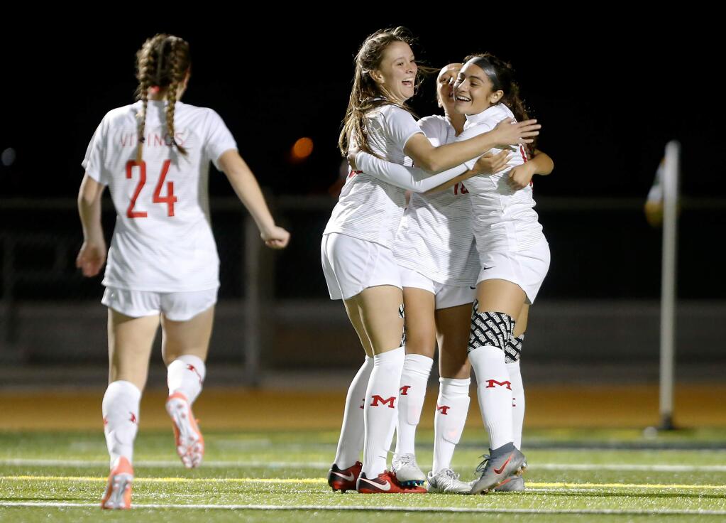 Montgomery's Paola Gomez (19), far right, Micky Rosenbaum (10), and Abria Brooker (23) celebrate after a Viking goal during the first half of a girls varsity soccer match between Montgomery and Maria Carrillo high schools, in Santa Rosa, California, on Thursday, January 23, 2020. (Alvin Jornada / The Press Democrat)