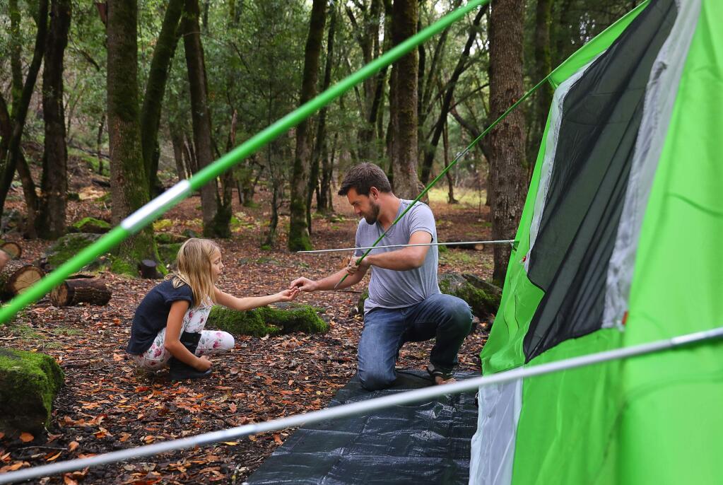 Mike Baker and his daughter, Caitlyn, 9, set up their new tent during their first camping trip, since the family lost their Coffey Park neighborhood home in the Tubbs fire, at Sugarloaf Ridge State Park on Thursday, October 4, 2018. (Christopher Chung/ The Press Democrat)