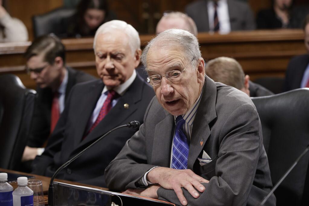 Senate Judiciary Committee Chairman Sen. Charles Grassley, R-Iowa, right, joined at left by Sen. Orrin Hatch, R-Utah, opens a meeting on Capitol Hill in Washington, Monday, March 27, 2017, before the arrival of the committee's ranking member,Sen. Dianne Feinstein, D-Calif. Senate Democrats forced a one-week delay in a committee vote on President Donald Trump's Supreme Court nominee, who remains on track for confirmation with solid Republican backing. (AP Photo/J. Scott Applewhite)