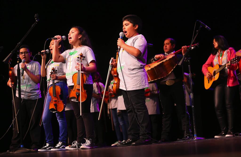 Juliana Avalos and Lorenzo Lopez sing with other participants of the Mariachi Summer Camp, and members of Mariachi Barragan, during the Los Cien event at the Luther Burbank Center for the Arts, in Santa Rosa on Friday, August 25, 2017. (Christopher Chung/ The Press Democrat)