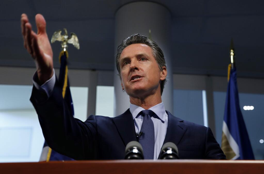 Gov. Gavin Newsom answers a question about a report he presented about the worsening wildfires in the state, during a news conference Friday, April 12, 2019, in Rancho Cordova, Calif. California could create its own power purchasing entity, change the standards that make utilities responsible for damages from wildfires and discourage new housing in areas at high risk of wildfire. Those are among the recommendations in a report Gov. Gavin Newsom presented Friday aimed at addressing a host of problems related to wildfires, chief among them how to maintain a safe, affordable electricity supply for California amid worsening fires. (AP Photo/Rich Pedroncelli)
