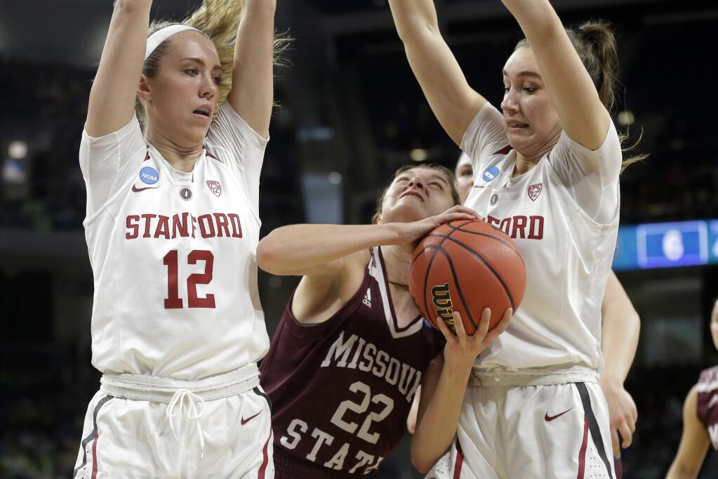 Missouri State's Alexa Willard (22) drives against Stanford's Lexie Hull (12) and Alanna Smith during the first half of a regional semifinal game in the NCAA women's tournament, Saturday, March 30, 2019, in Chicago. (AP Photo/Kiichiro Sato)