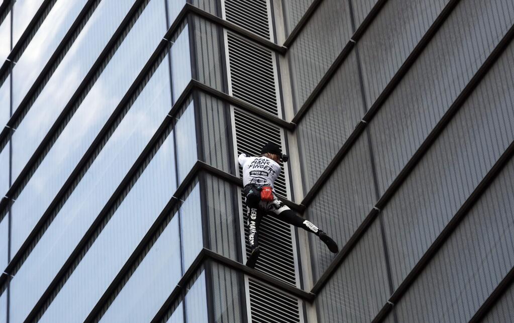 Climber dubbed the French Spiderman, Alain Robert scales the outside of the Heron Tower building in London, Thursday, Oct. 25, 2018. Heron Tower is over 200 metres high.(AP Photo/Frank Augstein)