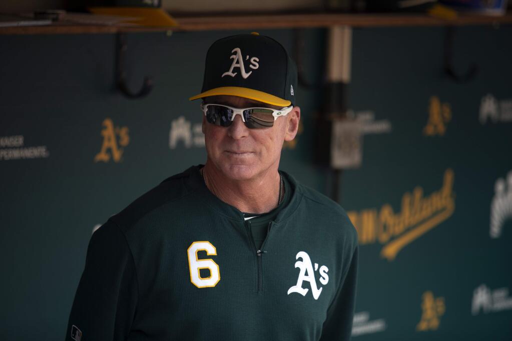 Oakland Athletics manager Bob Melvin in the dugout before a game against the Texas Rangers, Sunday, Sept. 22, 2019, in Oakland. (AP Photo/D. Ross Cameron)