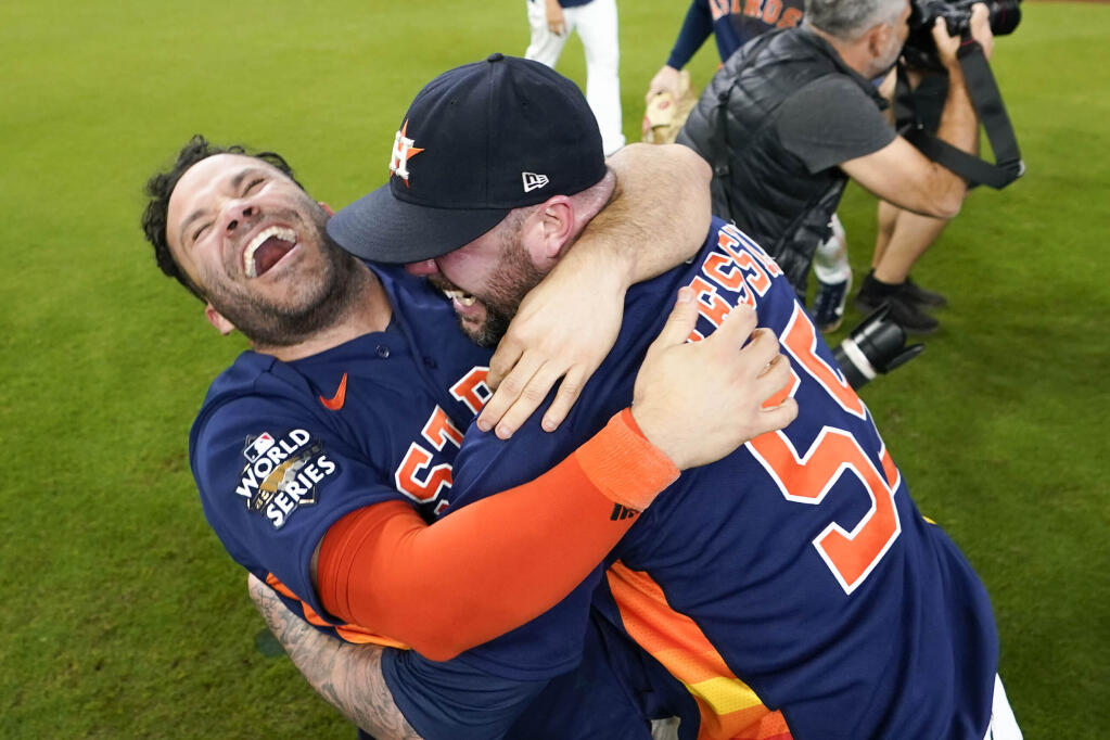 The Houston Astros’ Jose Altuve, left, embraces relief pitcher Ryan Pressly as they celebrate their 4-1 World Series win against the Philadelphia Phillies in Game 6 on Saturday, Nov. 5, 2022, in Houston. (AP Photo/David J. Phillip)