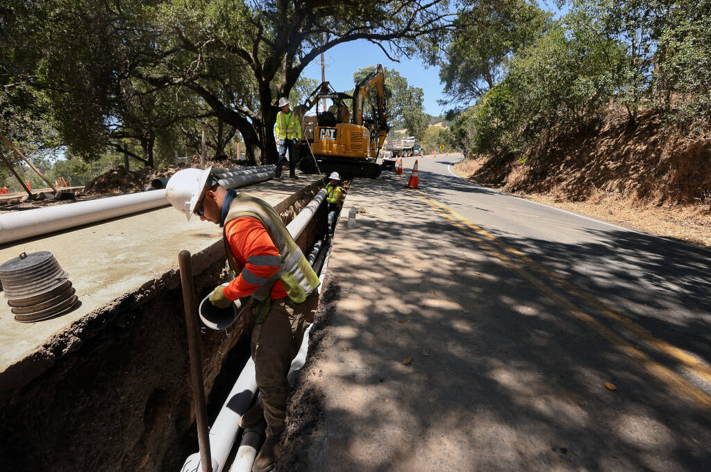 George Hosegera works on a PG&E project to move power lines underground along Calistoga Road, near Harville Road, in Santa Rosa on Monday, June 28, 2021.  PG&E is placing power lines underground in the area to help prevent customers from being impacted by Public Safety Power Shutoffs during severe weather conditions.  (Christopher Chung / The Press Democrat)