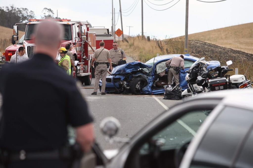 Crews work at the scene of a fatal accident on Lakeville Highway south of Petaluma on Thursday, Sept. 18, 2014. According to witnesses the gold car drifted over the center line and struck the blue car. The Driver of the gold car was pronounced dead at the scene. (SCOTT MANCHESTER/ARGUS-COURIER STAFF)