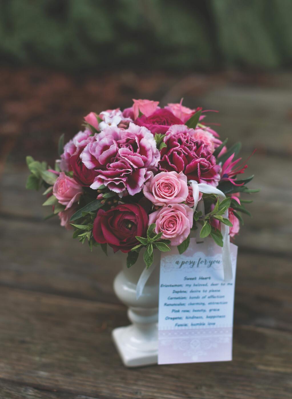 A posy is a small, round bouquet of flowers and herbs that are chosen based on their meanings to convey a message inspired by the Victorian-era language of flowers. Shown is a Sweet Heart Posy, given either to a daughter or a lover. It includes pink roses, fuschia, Eriostemon and Daphne. (Danyelle Dee)