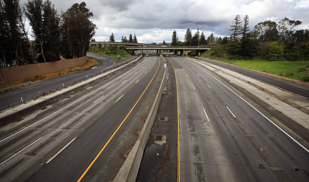 Highway 101 is almost empty of commute traffic at the Highway 12 interchange, Tuesday, March 24, 2020 in Santa Rosa. (Kent Porter / The Press Democrat) 2020