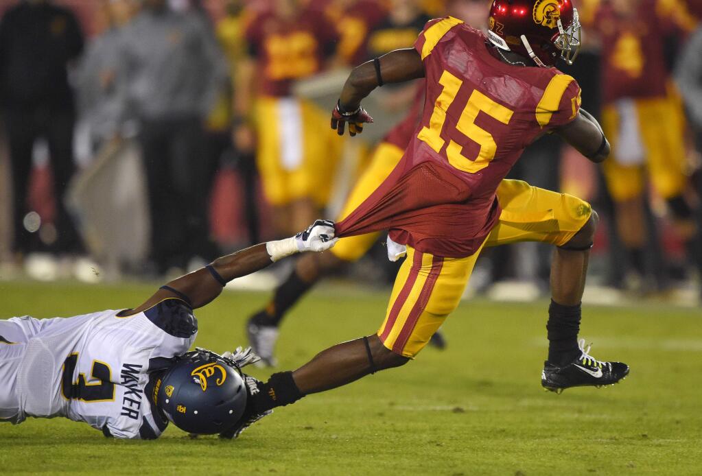 California cornerback Cameron Walker, left, tries to stop USC wide receiver Nelson Agholor during the first half of the game, Thursday, Nov. 13, 2014, in Los Angeles. (AP Photo/Mark J. Terrill)