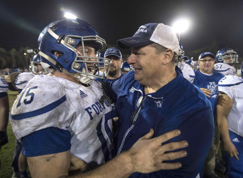 Fortuna head coach Mike Benbow, right, and JB Lewis celebrate after winning the CIF State Division 5-A championship against Katella at Glover Stadium in Anaheim on Saturday. (Kyusung Gong - The Orange County Register)