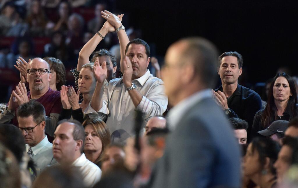 Parents of high school students applaud a question during a CNN town hall meeting, Wednesday, Feb. 21, 2018, at the BB&T Center, in Sunrise, Fla. (Michael Laughlin/South Florida Sun-Sentinel via AP)
