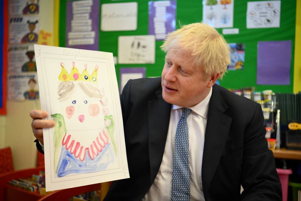 Britain's Prime Minister Boris Johnson holds up a portrait he painted of the Queen during a drawing session with children as part of a visit at the Field End Infant school, in South Ruislip, London, Friday May 6, 2022, following the local government elections. Britain’s governing Conservatives have suffered local election losses in their few London strongholds. Voting held Thursday for thousands of seats on more than 200 local councils decided who will oversee garbage collection and the filling of potholes, but were also seen as an important barometer of public opinion ahead of the next national election. (Daniel Leal/Pool via AP)