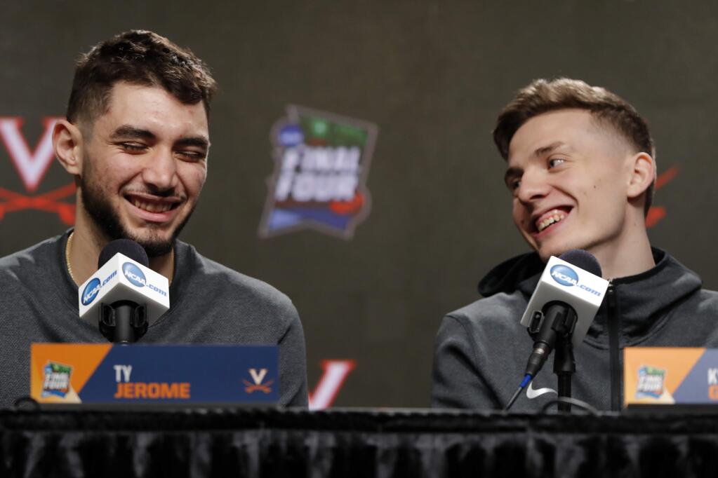 Virginia's Ty Jerome, left, and Kyle Guy laugh as they answer questions during a news conference for the championship of the Final Four NCAA college basketball tournament, Sunday, April 7, 2019, in Minneapolis. Virginia will play Texas Tech on Monday for the national championship. (AP Photo/Charlie Neibergall)