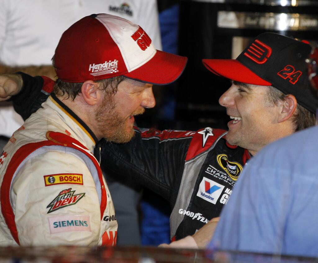 In this Feb. 23, 2014, file photo, Dale Earnhardt Jr., left, celebrates in Victory Lane with teammate Jeff Gordon, right, after winning the NASCAR Daytona 500 Sprint Cup series at Daytona International Speedway in Daytona Beach, Fla. (AP Photo/Terry Renna, File)