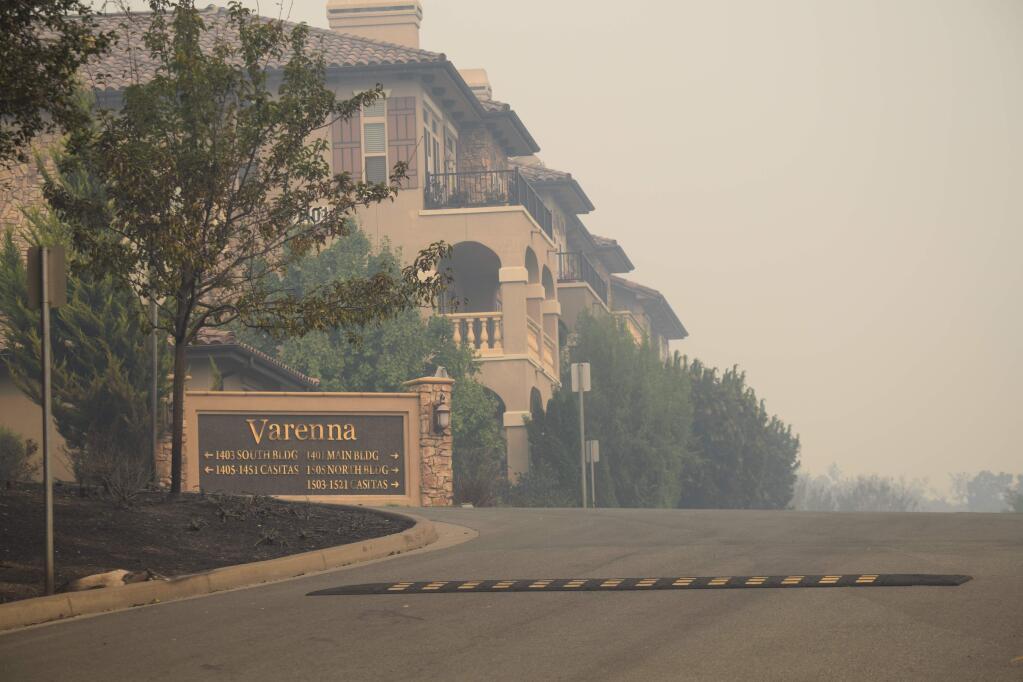 Much of the housing at Varenna survived the fire's destructive power, such as this building shrouded in smoke but intact. Firefighers from San Francisco attacked a fire in a nearby apartment complex a day after flames swept through here. (James Dunn / North Bay Business Journal)