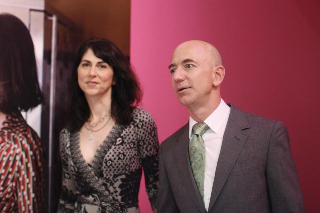 Jeff Bezos, the founder of Amazon.com, with his wife, MacKenzie Bezos at the opening party for Diane Von Furstenberg's exhibition 'Journey of a Dress' at the Wilshire May Company Building in Los Angeles, Jan. 10, 2014. The celebration marked the 40th birthday of Von Furstenberg's emblematic wrap dress. (Emily Berl/The New York Times)