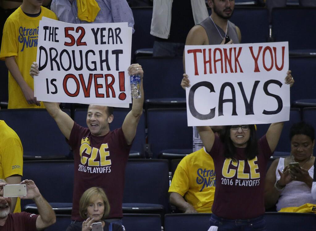 Cleveland Cavaliers fans hold up signs after Game 7 of basketball's NBA Finals between the Golden State Warriors and the Cavaliers in Oakland, Calif., Sunday, June 19, 2016. The Cavaliers won 93-89. (AP Photo/Eric Risberg)