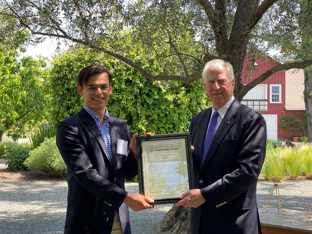 2022 Sonoma County Climate Crisis Champion Joseph Silvi accepts a plaque from Rep. Mike Thompson. (Photo courtesy of Dulce Silvi)