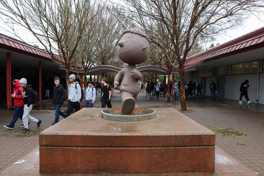 Students walk past the newly installed statue of Franklin, from “Peanuts,” at the beginning of the lunch period at Piner High School in Santa Rosa on Wednesday, Jan. 4, 2023. (Christopher Chung/The Press Democrat)