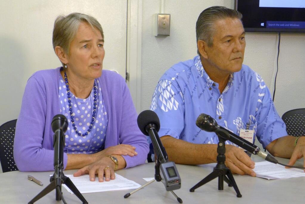 File - In this April 19, 2017, file photo, Hawaii Health Director Virginia Pressler, left, and Hawaii Tourism Authority CEO George Szigeti, right, talk to members of the media about new cases of rat lungworm disease in Honolulu. A California couple on their honeymoon and two people who drank a homemade beverage are among the rising number of victims in Hawaii falling ill with a potentially deadly brain parasite. After the newlyweds' plight with rat lungworm disease recently got attention online, the couple and some experts accused Hawaii of failing to adequately warn tourists and residents of the danger. Tourism officials are assuring visitors that the disease is rare and there's no need to cancel vacation plans. (AP Photo/Cathy Bussewitz, File)