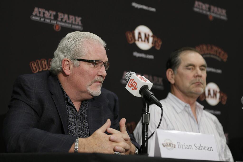 San Francisco Giants general manager Brian Sabean, left, answers questions as manager Bruce Bochy, right, listens during a news conference at AT&T Park Thursday, Nov. 6, 2014, in San Francisco. After capturing a third championship in five years, the Giants baseball team faces another busy winter in which they will try to re-sign switch-hitting third baseman Pablo Sandoval. (AP Photo/Eric Risberg)