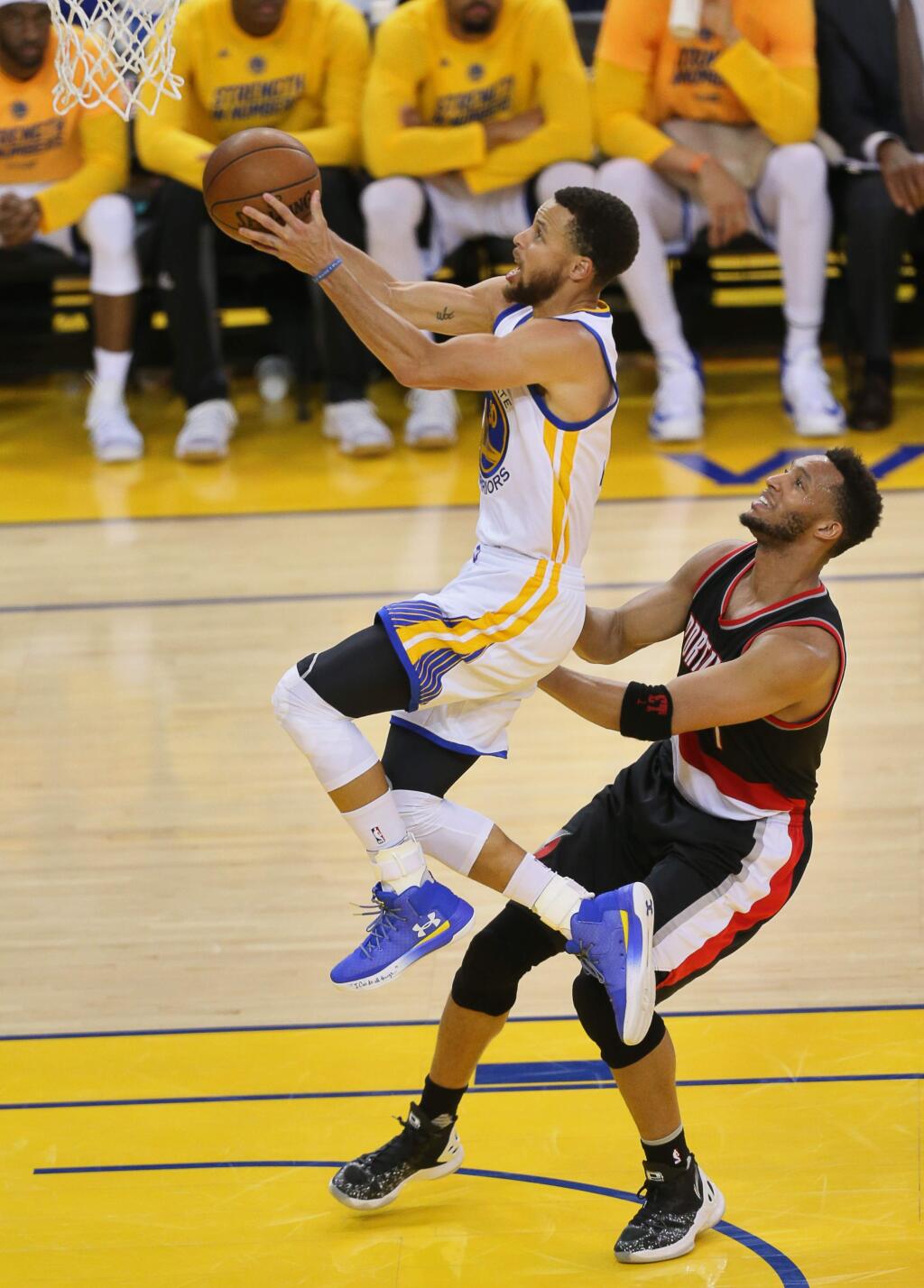 Golden State Warriors guard Stephen Curry goes up for a layup against Portland Trailblazers guard Evan Turner during Game 2 of the first round of NBA playoffs in Oakland on Wednesday, April 19, 2017. (Christopher Chung/ The Press Democrat)
