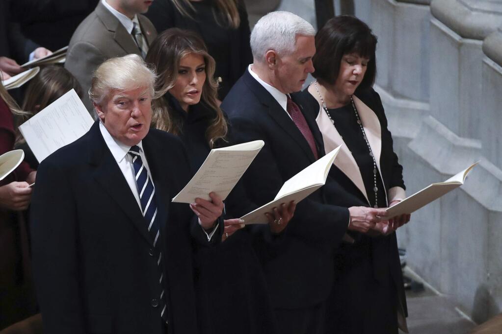 From left, President Donald Trump, first lady Melania Trump, Vice President Mike Pence and his wife Karen, sing together during a National Prayer Service at the National Cathedral, in Washington, Saturday, Jan. 21, 2017. (AP Photo/Manuel Balce Ceneta)