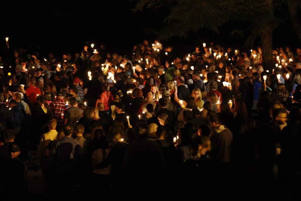 People gather for a candlelight vigil at Stewart Park in Roseburg, Ore., after a shooting with multiple fatalities occurred at Umpqua Community College, Thursday, Oct. 1, 2015. (Randy L. Rasmussen/The Oregonian via AP)