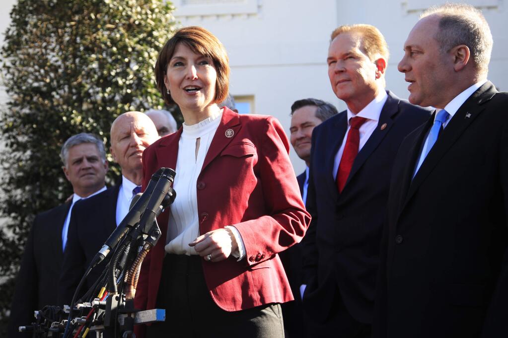 Rep. Cathy McMorris Rodgers, R-Wa., together with Rep. Kevin Brady, R-Texas, left, Rep. Rep. Steve Scalise, R-La., right, Rep. Vern Buchanan, R-Fla., second from right, and other Republican members of Congress speaks to reporters outside the West Wing of the White House following a meeting with President Donald Trump at the White House in Washington, Tuesday, March 26, 2019. (AP Photo/Manuel Balce Ceneta)