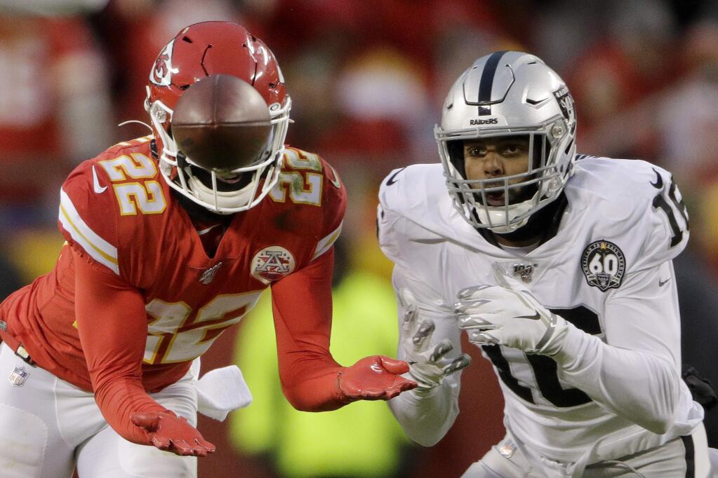 Kansas City Chiefs safety Juan Thornhill (22) intercepts a pass intended for Oakland Raiders wide receiver Keelan Doss (18) and returns it for a touchdown during the first half of an NFL football game in Kansas City, Mo., Sunday, Dec. 1, 2019. (AP Photo/Charlie Riedel)