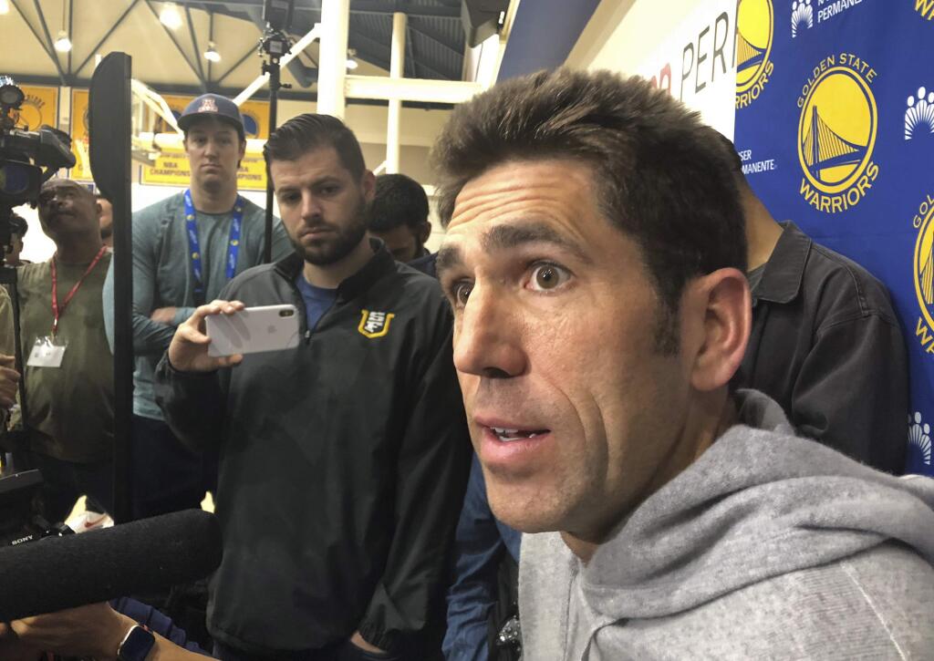 Golden State Warriors general manager Bob Myers talks with reporters at the team's practice facility Friday, June 14, 2019, in Oakland. Their three-peat quest denied by the champion Toronto Raptors, the Warriors now brace for major uncertainty ahead as Kevin Durant begins a long rehab from right Achilles tendon surgery and must decide where to sign, and Klay Thompson has a torn left ACL that will be another lengthy recovery. (AP Photo/Janie McCauley)