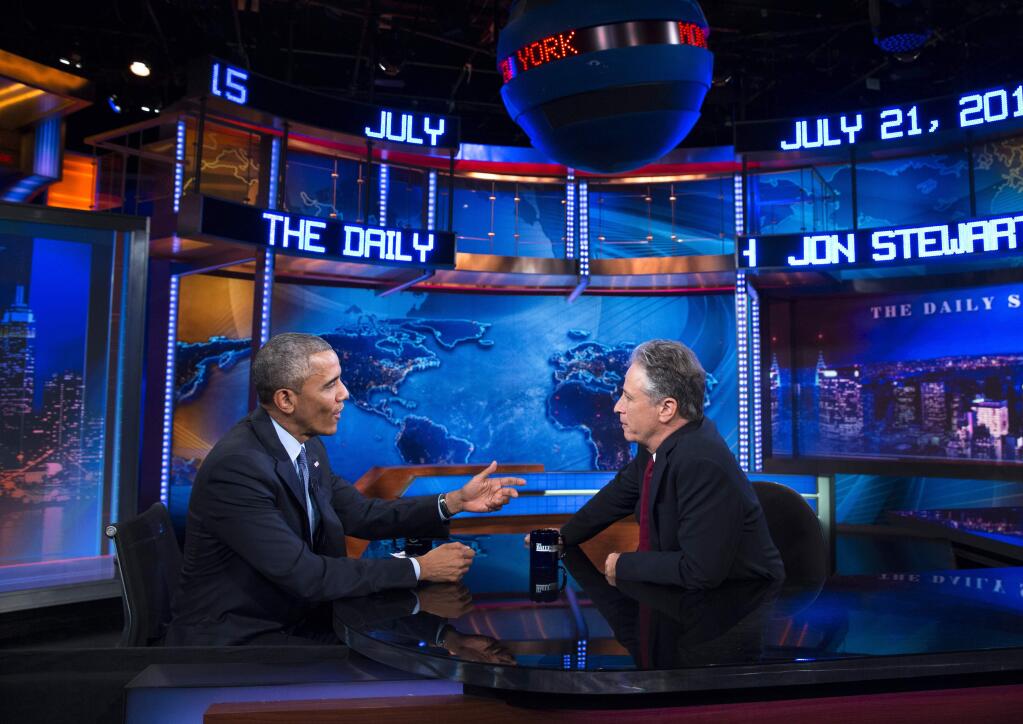 FILE - In this July 21, 2015 file photo, President Barack Obama, left, talks with Jon Stewart, host of 'The Daily Show with Jon Stewart' during a taping in New York. (AP Photo/Evan Vucci, File)