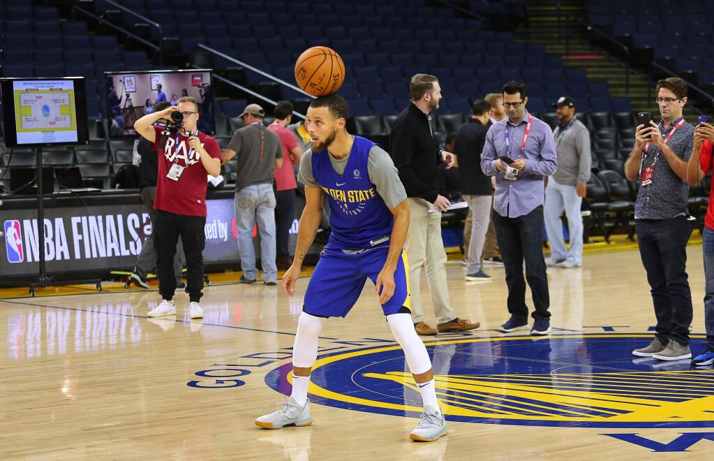 Golden State Warriors guard Stephen Curry bounces the ball on his head before hitting a jump shot during the NBA Finals Media Day, in Oakland on Wednesday, May 30, 2018.. (Christopher Chung / The Press Democrat)