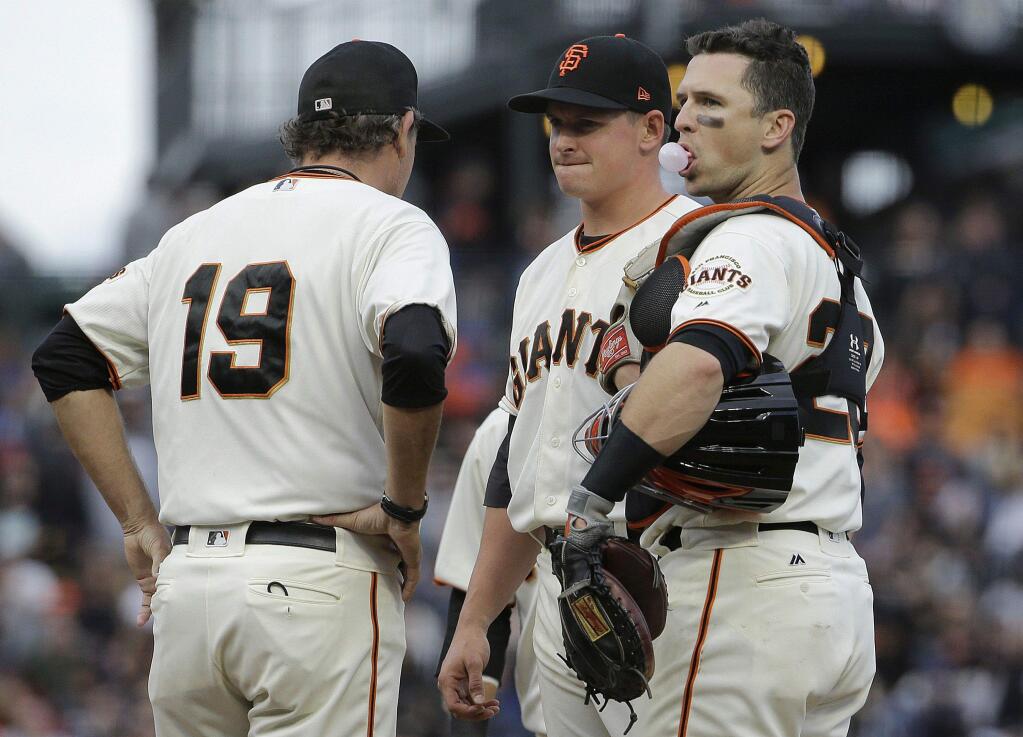 San Francisco Giants pitcher Kyle Crick, center, meets on the mound with pitching coach Dave Righetti, right, and catcher Buster Posey during the ninth inning of the team's game against the New York Mets in San Francisco, Saturday, June 24, 2017. The Mets won 5-2. (AP Photo/Jeff Chiu)