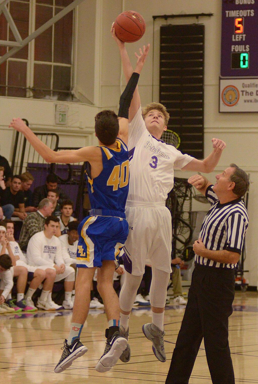 SUMNER FOWLER/FOR THE ARGUS-COURIERPetaluma started its season right with Jack Anderson winning the opening tip from Terrqa Linda's Reece Feehr. Petaluma went on to win the game, 69-40.