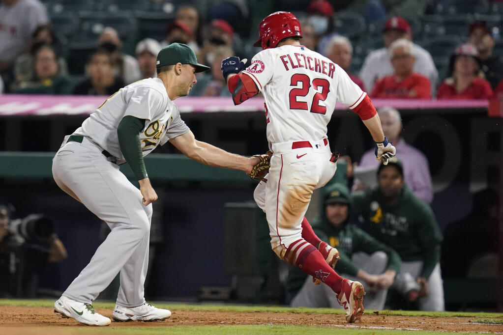 The Los Angeles Angels’ David Fletcher is tagged out by Oakland Athletics first baseman Matt Olson during the seventh inning on Friday, Sept. 17, 2021, in Anaheim. (Ashley Landis / ASSOCIATED PRESS)