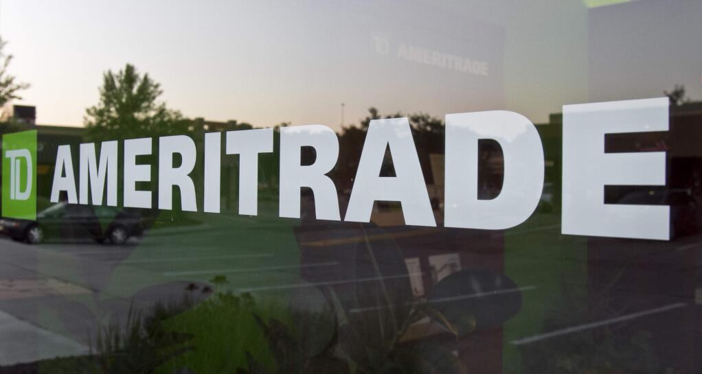 FILE - In this July 18, 2010, file photo, a TD Ameritrade logo is displayed on the office in Omaha, Neb. Online brokerage TD Ameritrade is buying Scottrade Financial Services Inc., announced Monday, Oct. 24, 2016, in a cash-and-stock deal valued at about $4 billion, which will help bolster its retail business and more than quadruple the size of its branch network. (AP Photo/Nati Harnik, File)
