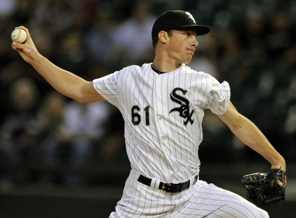 Chicago White Sox starter Chris Bassitt delivers a pitch during the first inning of a baseball game against the Oakland Athletics in Chicago, Wednesday, Sept. 10, 2014. (AP Photo/Paul Beaty)