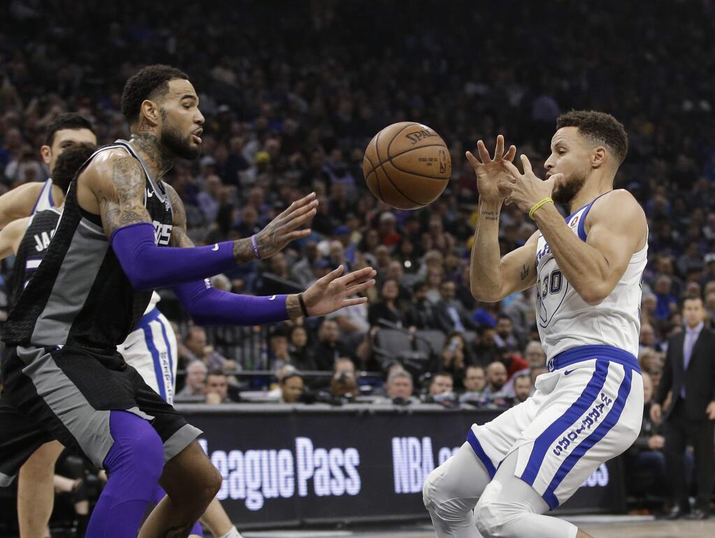 Sacramento Kings center Willie Cauley-Stein, left, and Golden State Warriors guard Stephen Curry go for the ball during the first quarter of an NBA basketball game Friday, Feb. 2, 2018, in Sacramento, Calif. (AP Photo/Rich Pedroncelli)