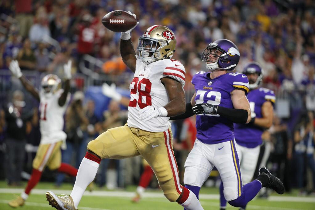 San Francisco 49ers running back Carlos Hyde catches a 24-yard touchdown pass in front of Minnesota Vikings free safety Harrison Smith, right, during the first half of an NFL preseason football game Sunday, Aug. 27, 2017, in Minneapolis. (AP Photo/Bruce Kluckhohn)