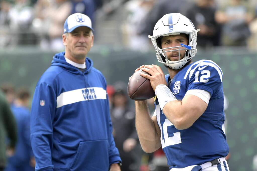 In this Oct. 14, 2018, file photo, Indianapolis Colts quarterback Andrew Luck warms up as head coach Frank Reich looks on prior to a game against the New York Jets, in East Rutherford, New Jersey. (AP Photo/Bill Kostroun, File)
